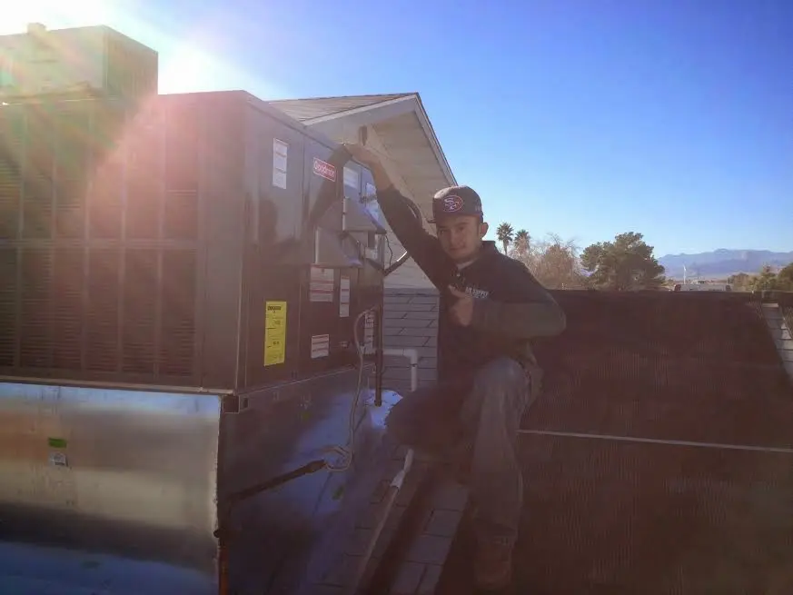 HVAC technician performing AC Tune-Up on a rooftop unit in Lake Wylie